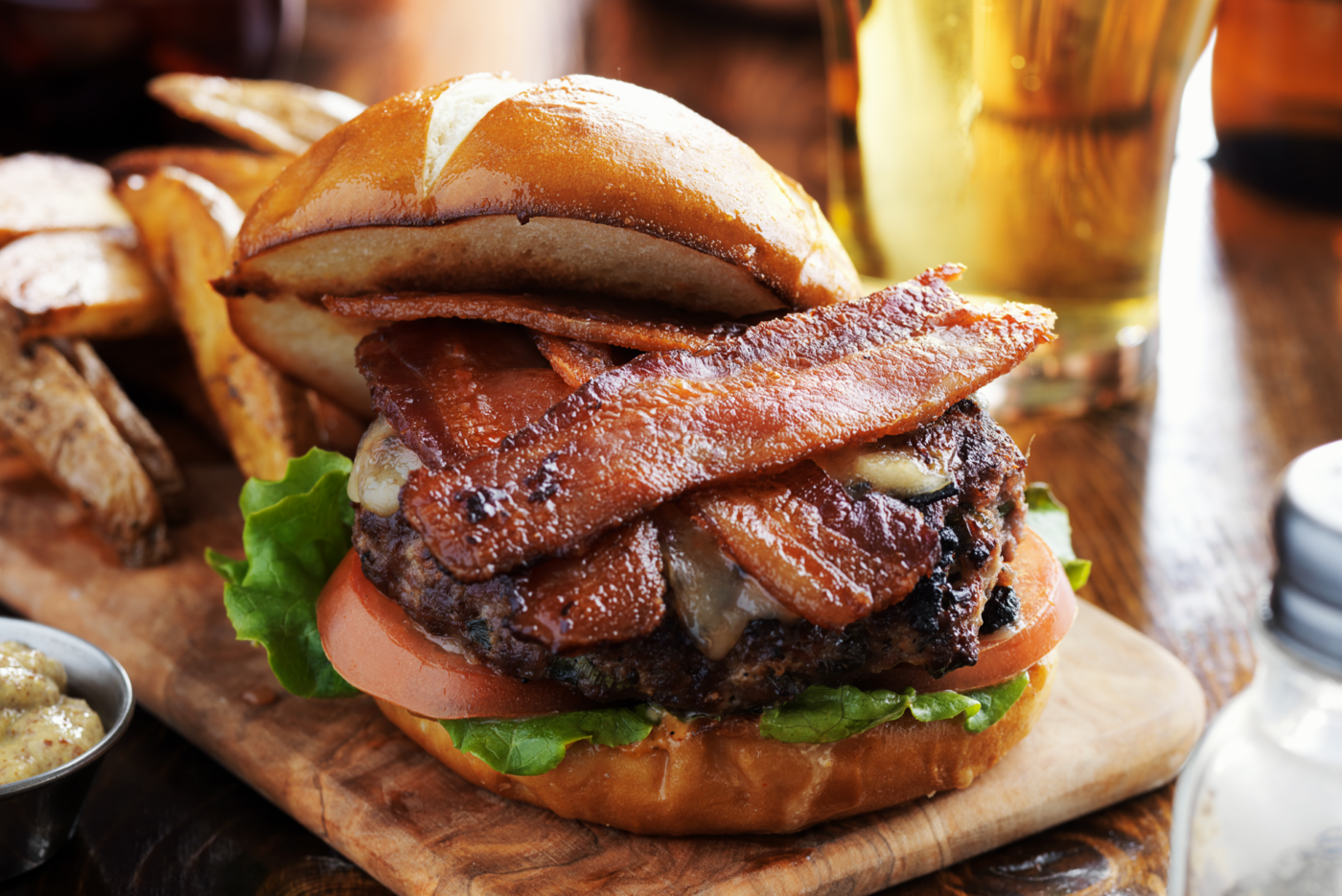 bacon burger with pretzel bun and fries