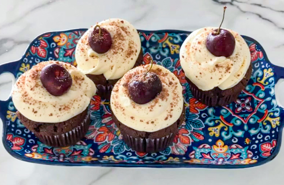 Tray full of Black Forest Cupcakes with Cherry Filling on the marble countertop