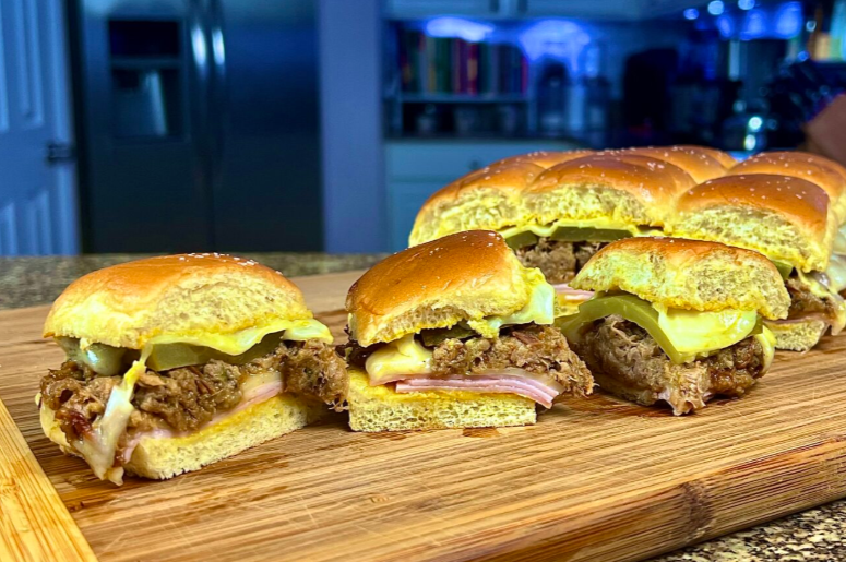 Cuban Sliders with Mojo Pork on the cutting board with the kitchen in the background