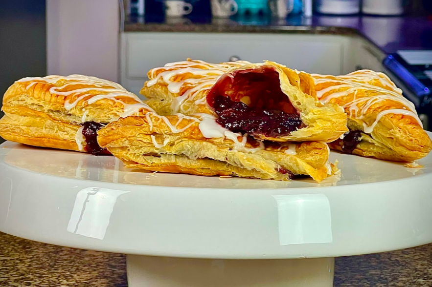 Easy Mixed Berry Turnovers on the white platter, side shot with the kitchen in the background