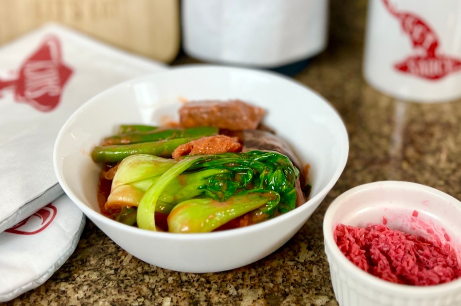 Filipino Beef Stew Kare-Kare in the serving bowl, on the kitchen countertop, medium distance side shot