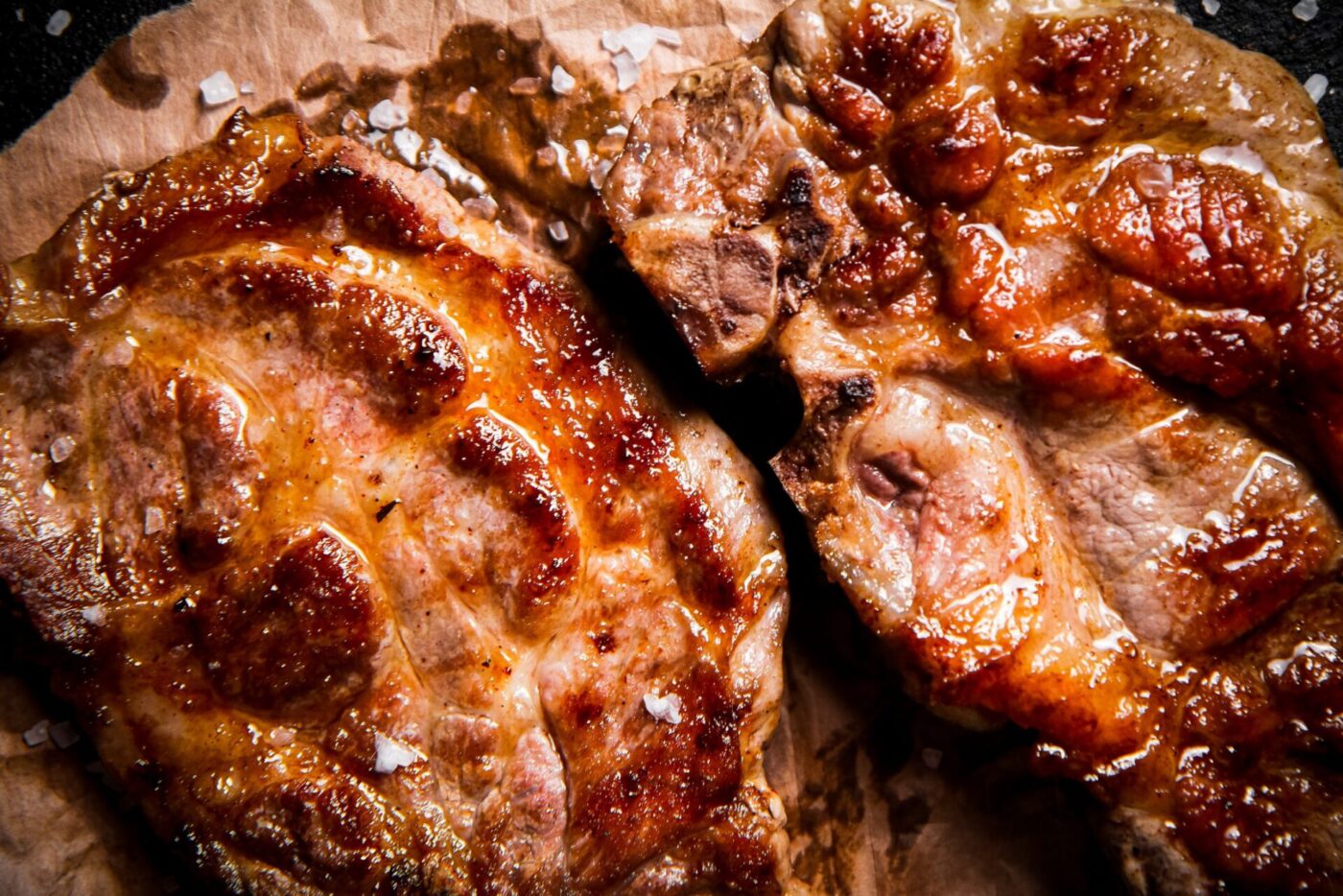 Grilled pork steak on paper. Macro background. High quality photo