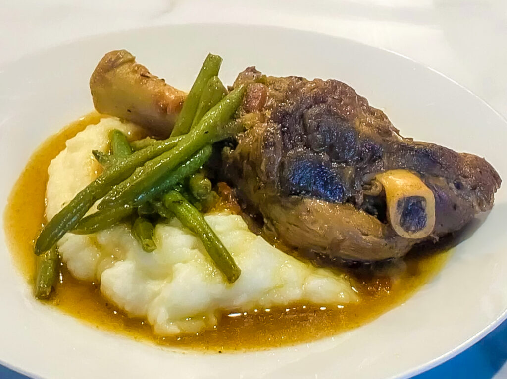 Slow-Cooked Goat Shanks in Rich Spiced Gravy, detail side view