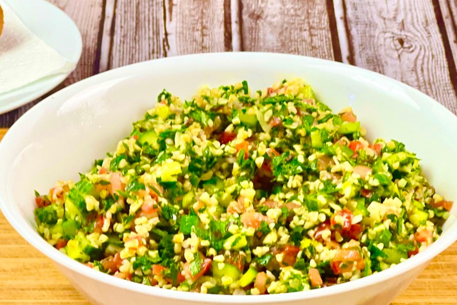 Close up shot to Tabbouleh Salad in the serving bowl, on the rustic table