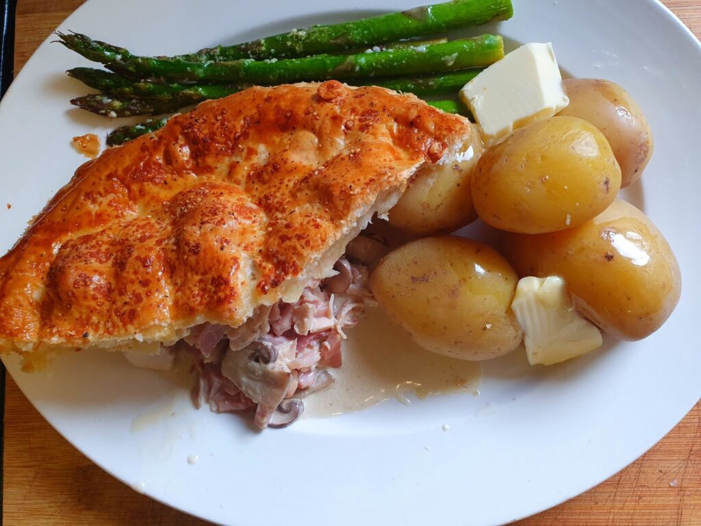 Chicken, Ham And Mushroom Pie with potatoes on the plate in detail.